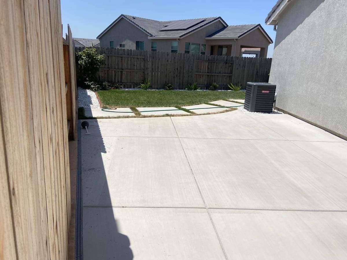 Concrete side-yard slab and walkway alongside a home