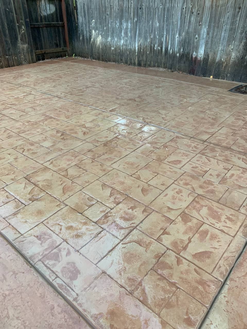 Tan ashlar-pattern stamped concrete patio