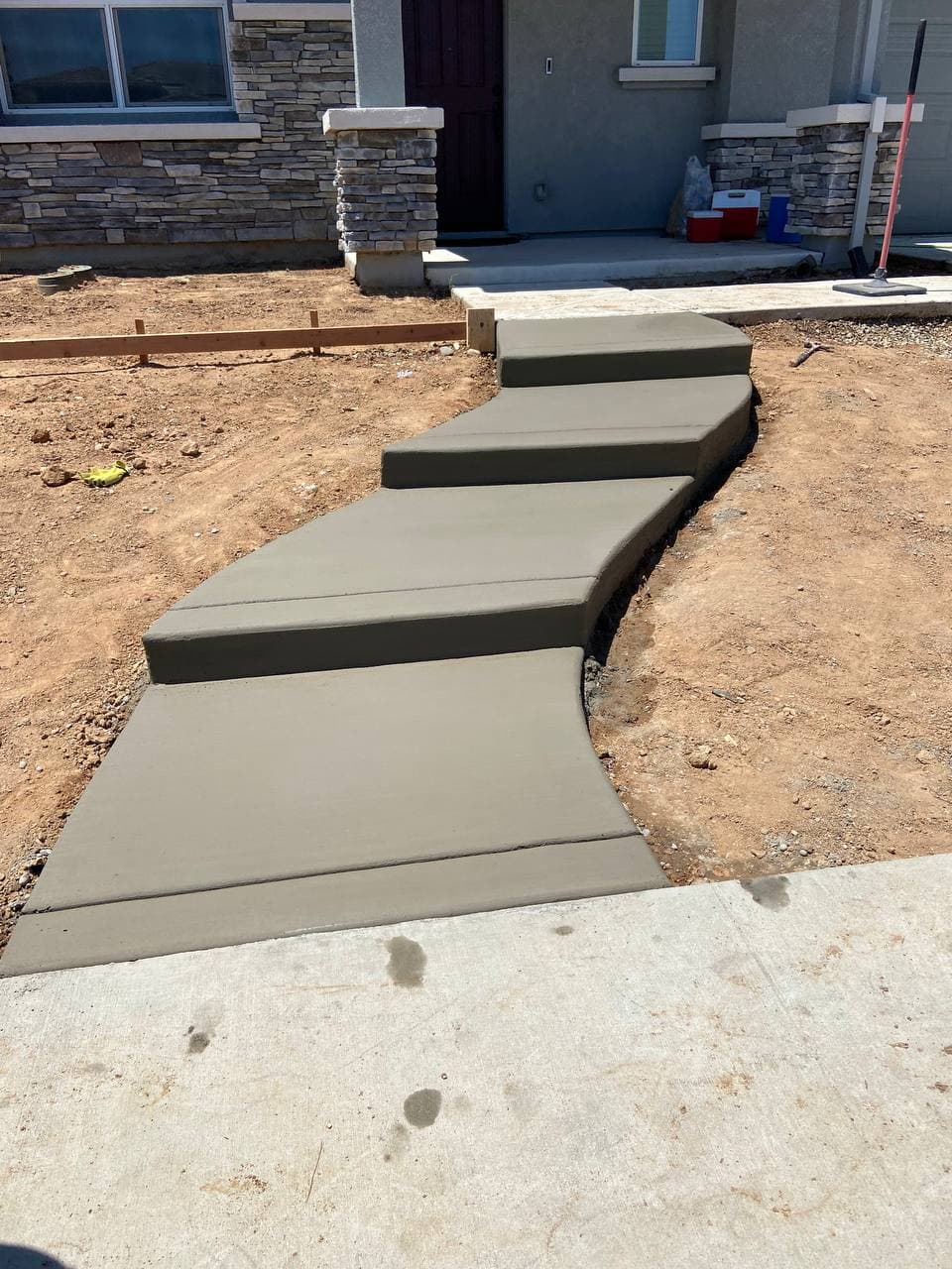 Concrete entry walkway with stepped charcoal-accent risers